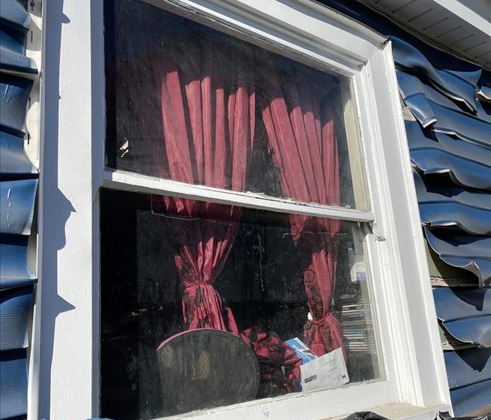 Fire damage house window in Gardena 